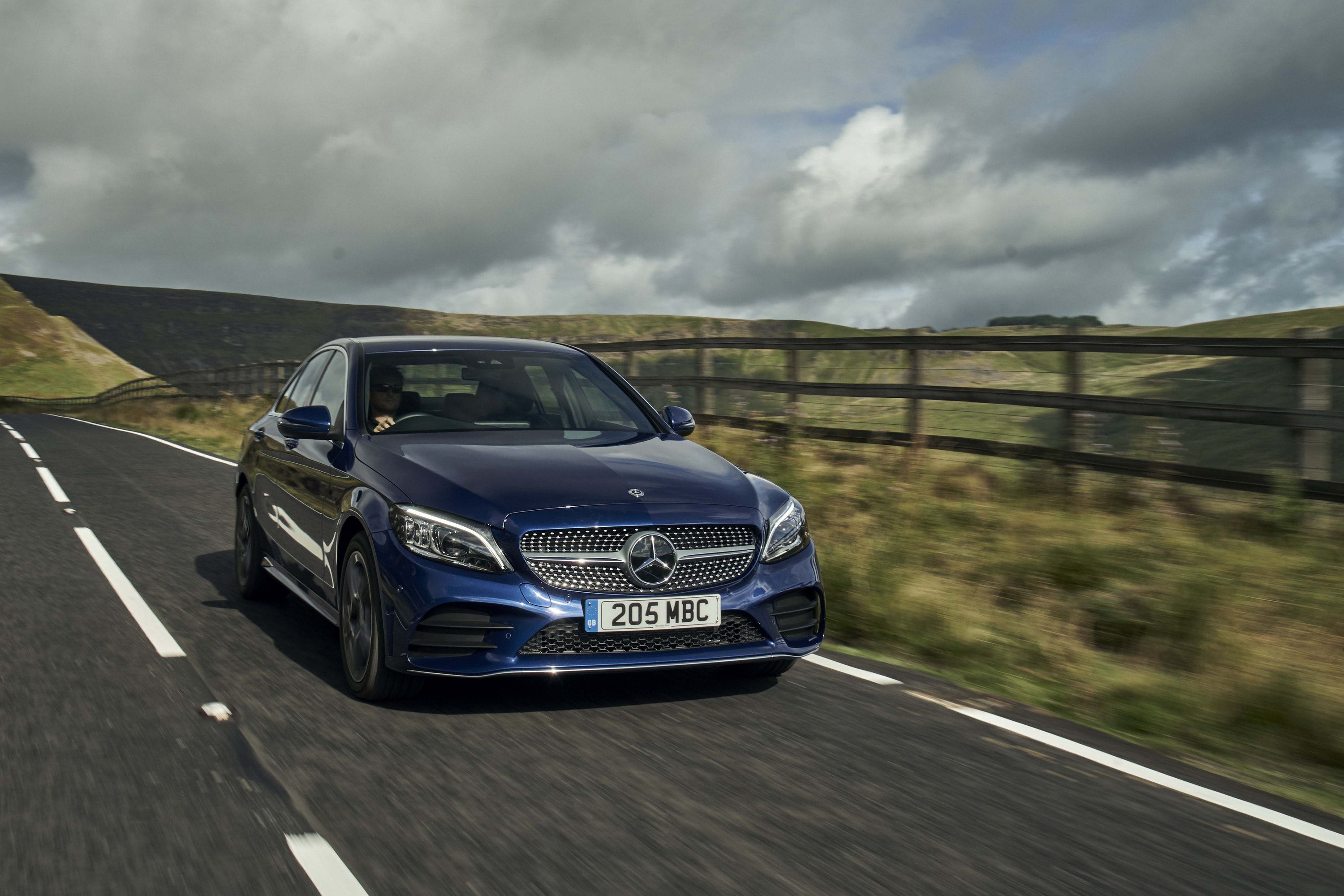 Blue Mercedes-Benz C-Class driving front view